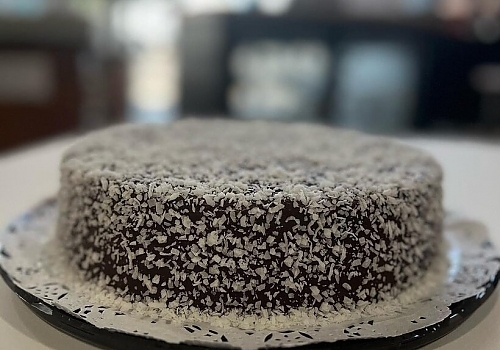 A cake with a piece of cake on top of it showcasing chicago bakery.