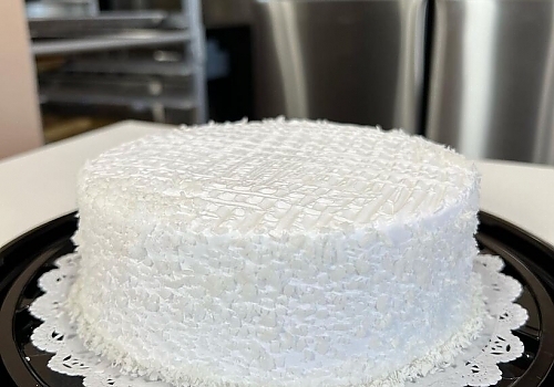 A white cake with a white frosting on top showcasing rumchata tres leches.