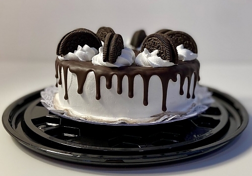 A cake with a oreos on top of it showcasing wedding cakes.