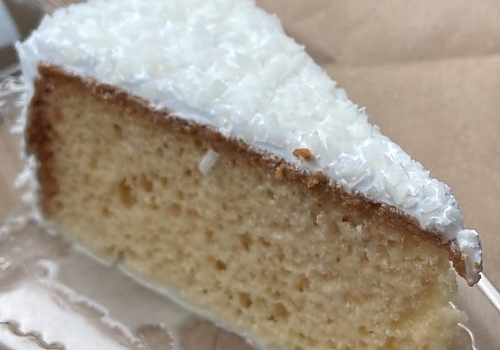 A piece of cake with frosting on it showcasing cappuccino tres leches.